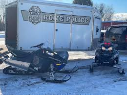 snow mobiles outside rome police department trailer