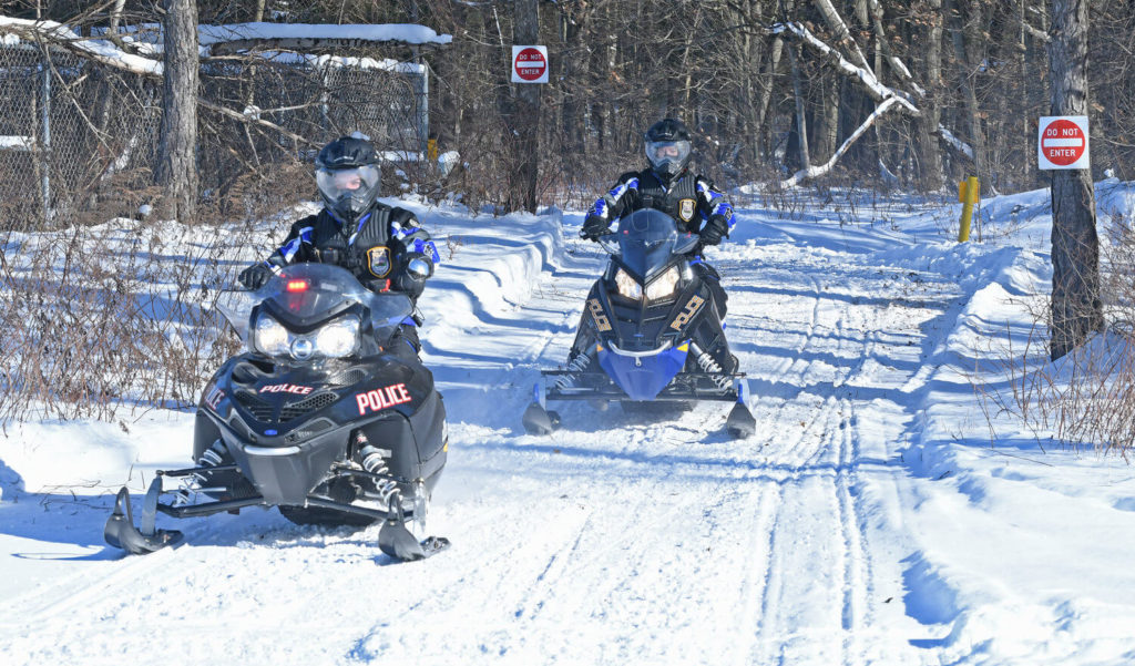 rome police department officers riding snowmobiles