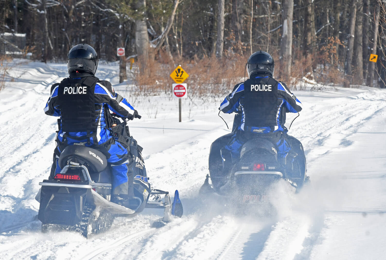 two all terrain unit officers for rome police department riding snowmobiles